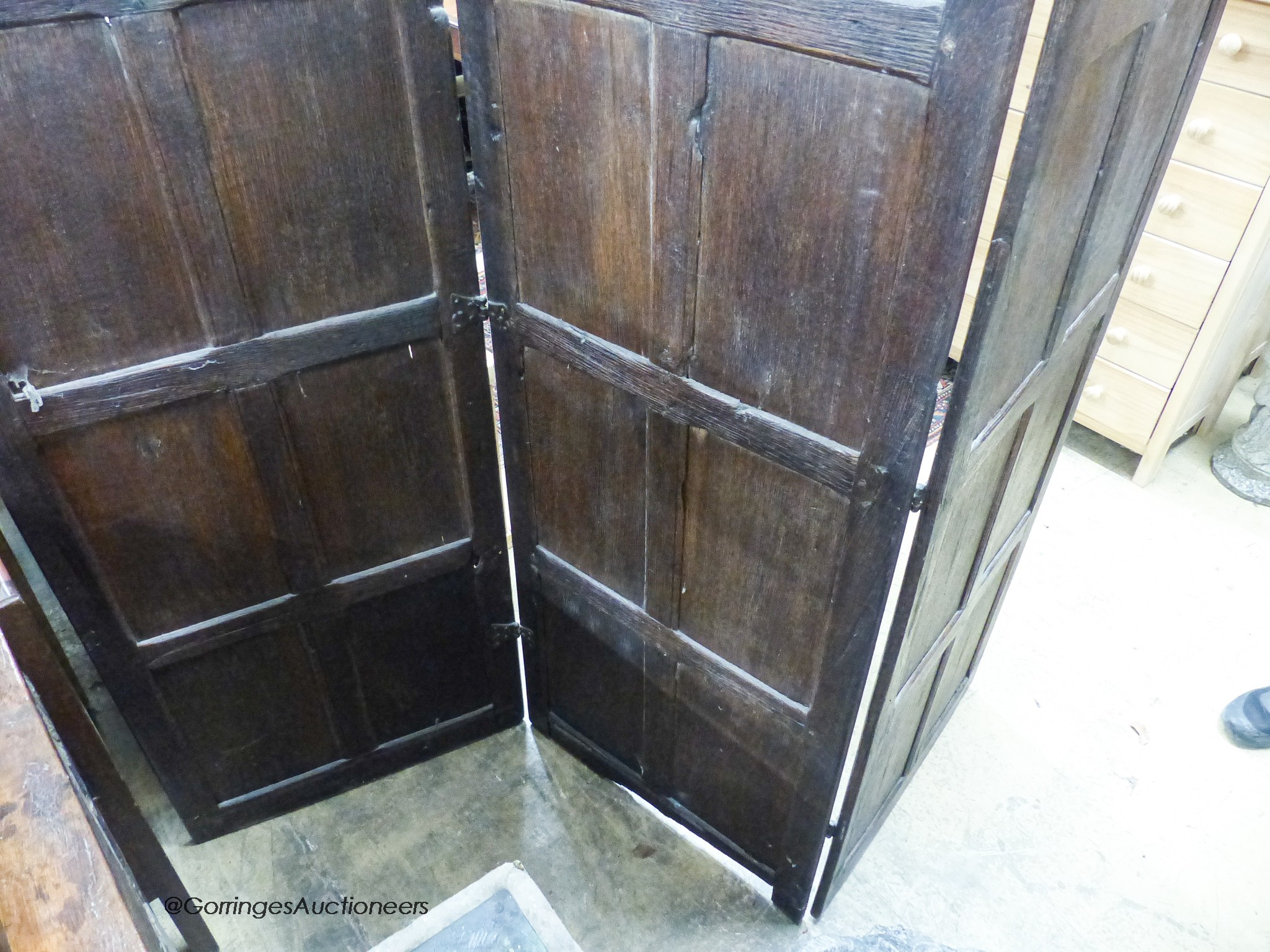 An oak three-fold screen incorporating twenty-four 16th / 17th century linenfold-carved panels, each panel width 59cm, height 182cm